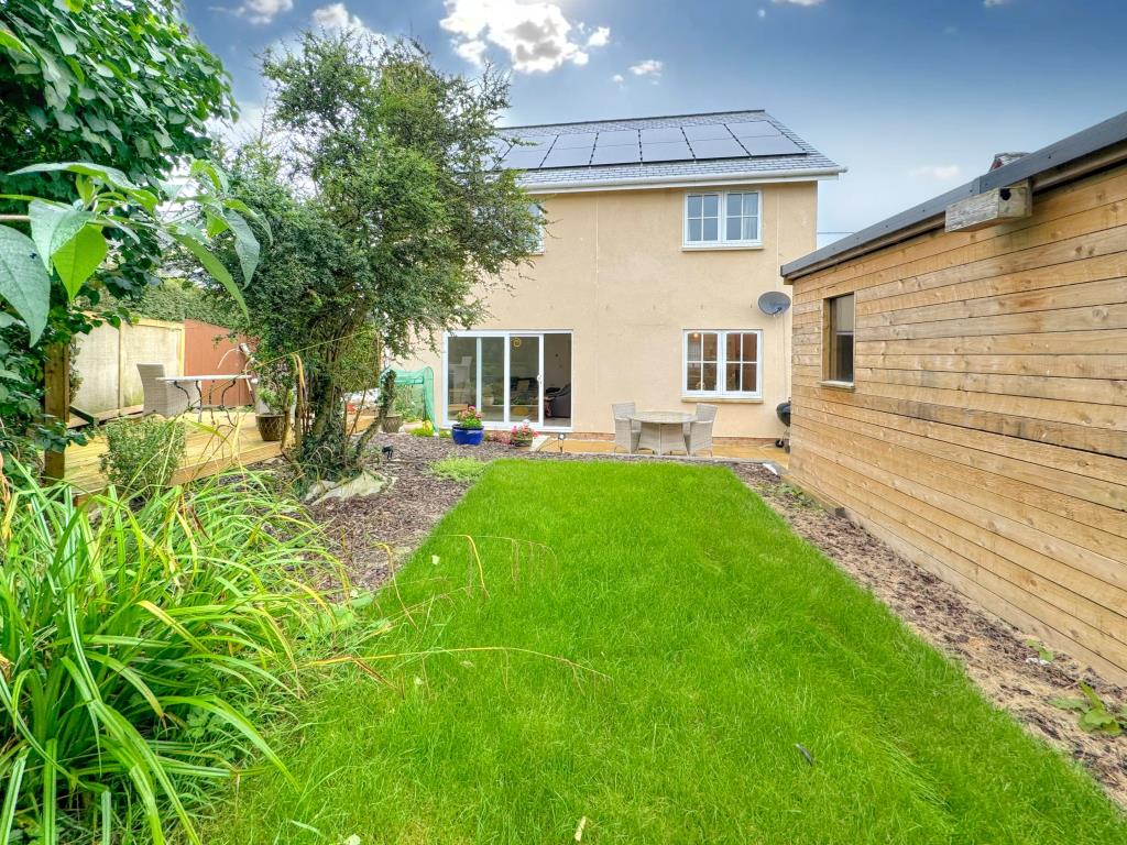 Lot: 142 - THREE-BEDROOM NEW BUILD HOME - Garden looking at the rear of the house with solar panels on roof